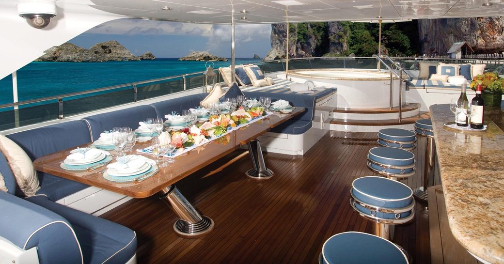 Sundeck bar and seating with Jacuzzi beyond on superyacht Lady Joy