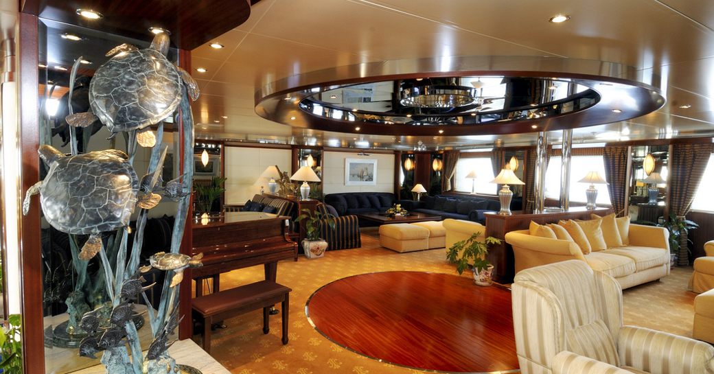 The golden carpets and modern sculptures found in the main salon of superyacht Lauren L