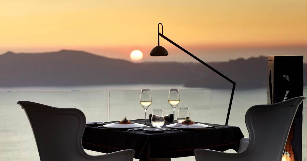 Fine dining experience overlooking a beautiful sunset in Santorini