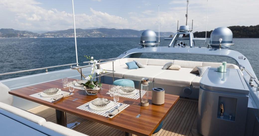 Overview of alresco dining on the sun deck of charter yacht 55 FIFTYFIVE