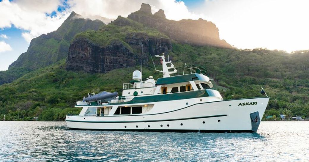 charter yacht, a classic yacht ASKARI surrounded by beautiful landscape in French Polynesia