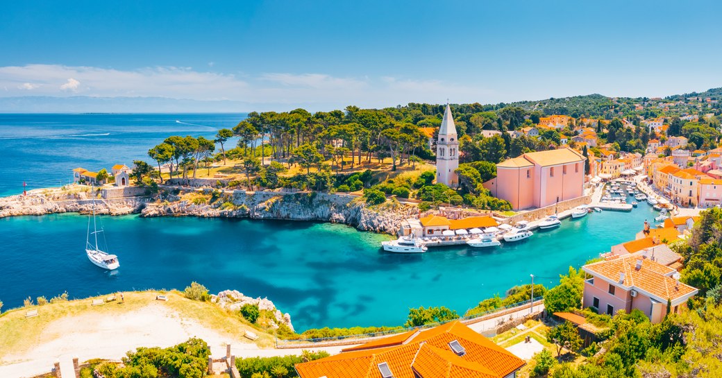 Scenic view of the blue lagoon village Veli Losinj on sunny day. Location place Kvarner Gulf, island Losinj, Croatia, Europe. Drone photography. Summer vacation concept. Discover the beauty of earth.