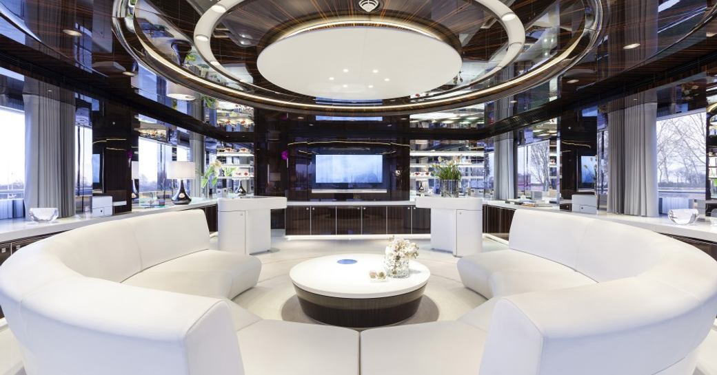 Fresh white furnishings arranged in the main salon of superyacht MYSKY