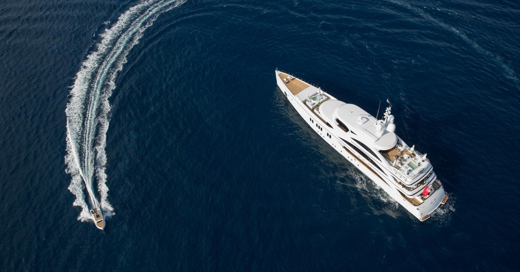 Luxury yacht 11/11 from Benetti at anchor, with tender circling 