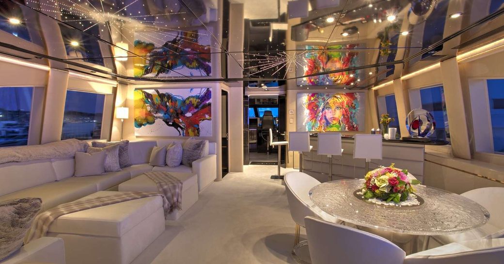 Superyacht INVISION interiors, with mirrored ceiling panels and cream sofas