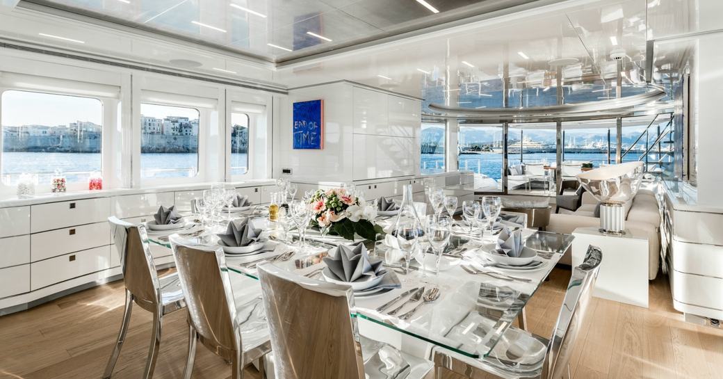 DESTINY glass-topped dining table in the main salon of superyacht DESTINY