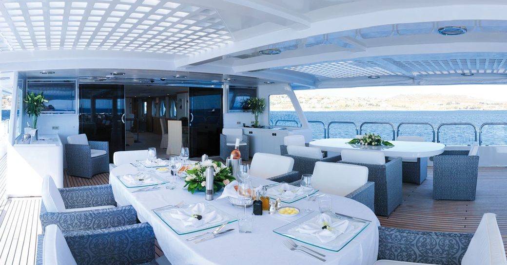 Alfresco dining area on deck of luxury yacht magna grecia