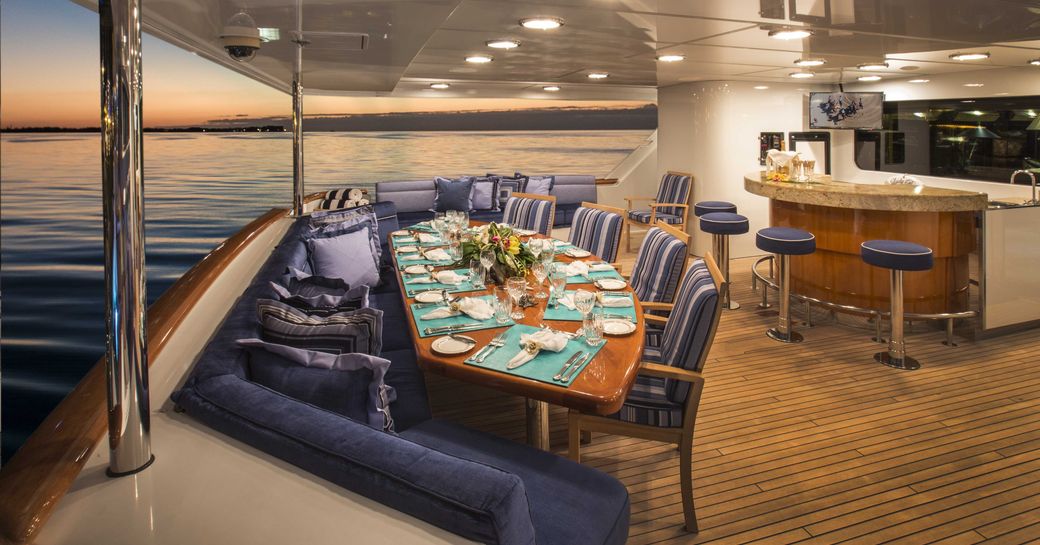 Aft deck dining and bar on charter yacht Lady Bee at sundeck