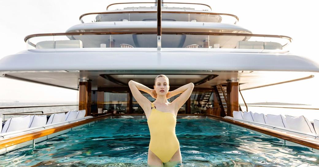 charter guest stands in pool on superyacht faith 