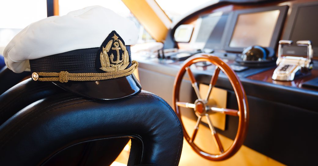 A captain's cap in a yacht bridge