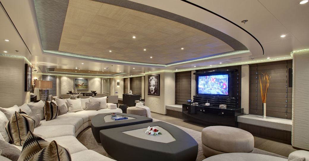 huge curved sofa and widescreen TV in main salon of charter yacht ‘Hurricane Run’ 