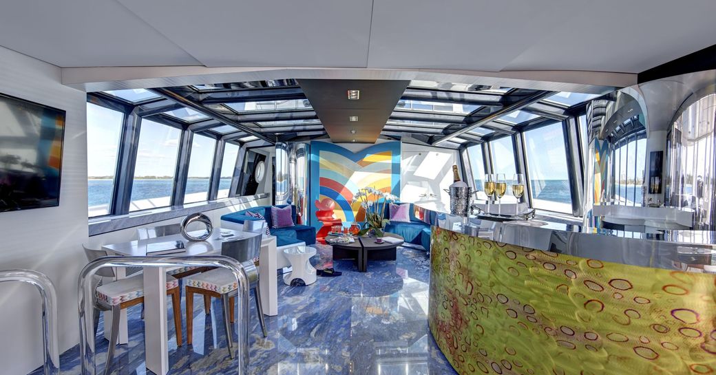 Skylounge on luxury yacht HIGHLANDER with glass ceiling and blue marble floors