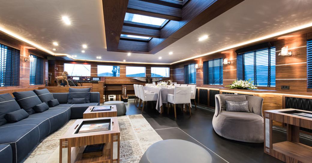 light filled main salon with skylight, lounge and dining area on board luxury yacht ‘Rox Star’ 