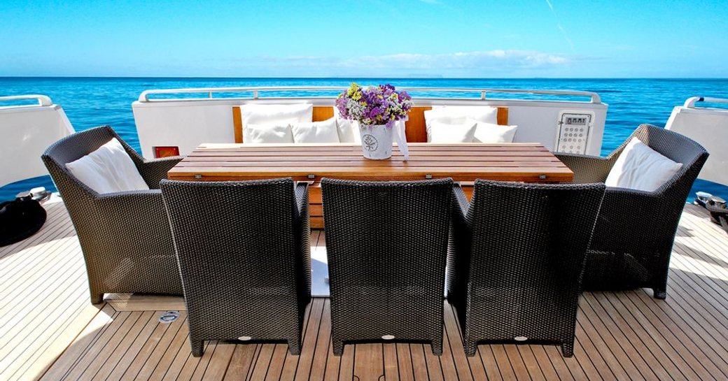 Alfresco dining on board superyacht Tropicana with blue skies in background