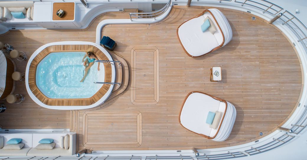 woman relaxing in a Jacuzzi on the sundeck of superyacht driftwood