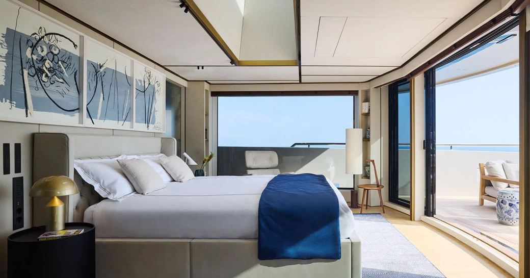 Master cabin onboard charter yacht LA LA LAND, central berth facing private exterior deck space through sliding door