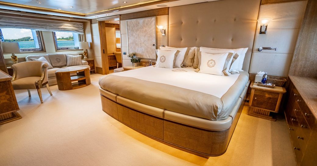 Master cabin onboard charter yacht ARTEMISEA, central berth facing forward with plush lounge area to port