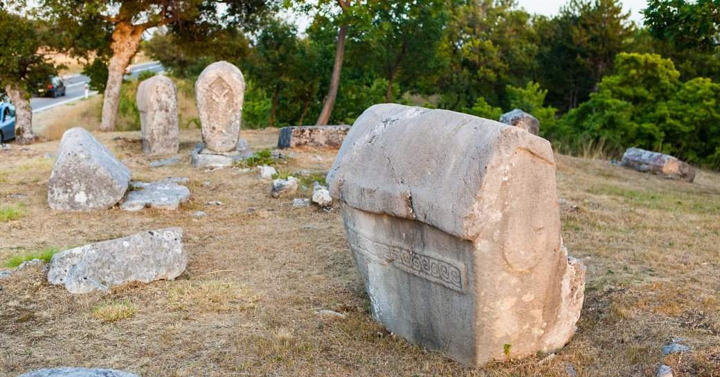 Ancient Stecci limestone tombstones with intricate carvings and inscriptions, Croatia