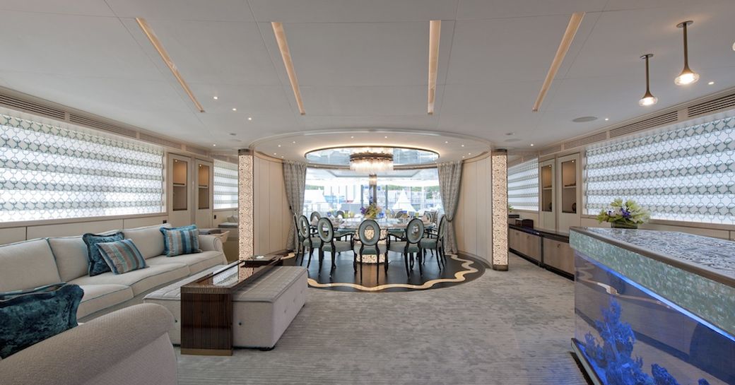 upper salon with fish tank and beautiful dining area on board motor yacht SCORPION 