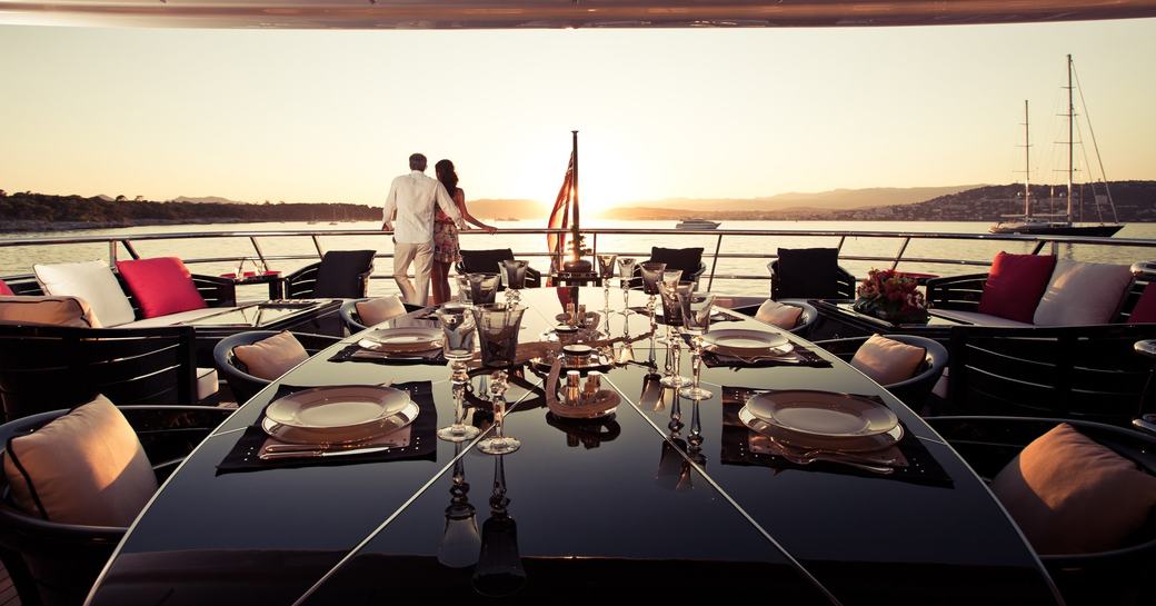 black lacquer table on upper deck aft at dusk on board superyacht ‘Step One’ 