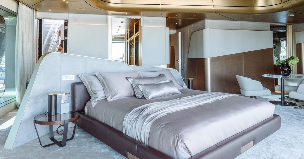Master cabin onboard charter yacht THIS IS IT, with central berth facing forward and a seating area to starboard