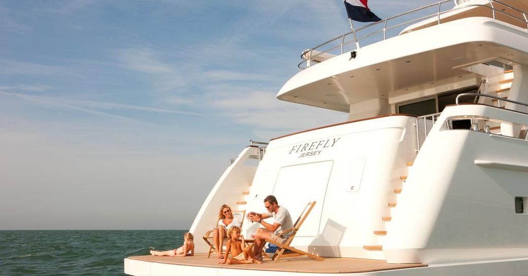 charter guests relax on luxury yacht firefly at anchor