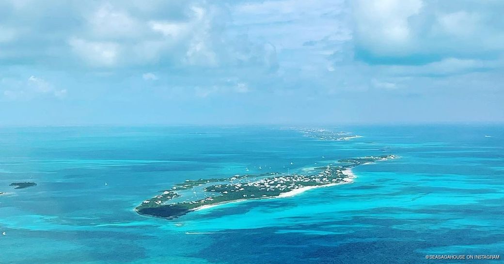 Extreme long shot out over Man-O-War Cay surrounded by crystal blue water 