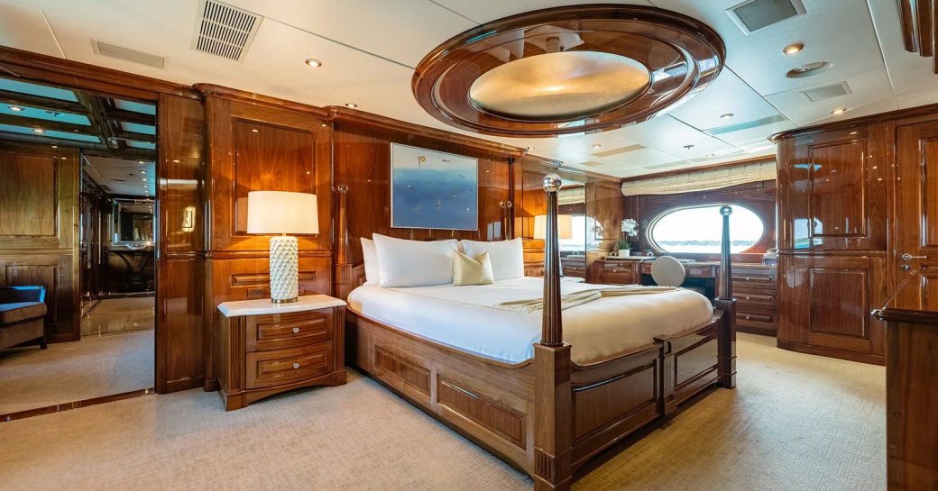 Master cabin onboard superyacht charter REMEMBER WHEN, central berth with oval window in the background