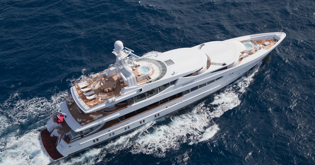 aerial and starboard-side view of superyacht SUNRISE as she cruises on a luxury yacht charter in Thailand