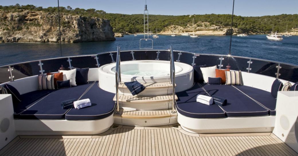 Jacuzzi surrounded by sunpads on the sundeck of motor yacht Sequel P