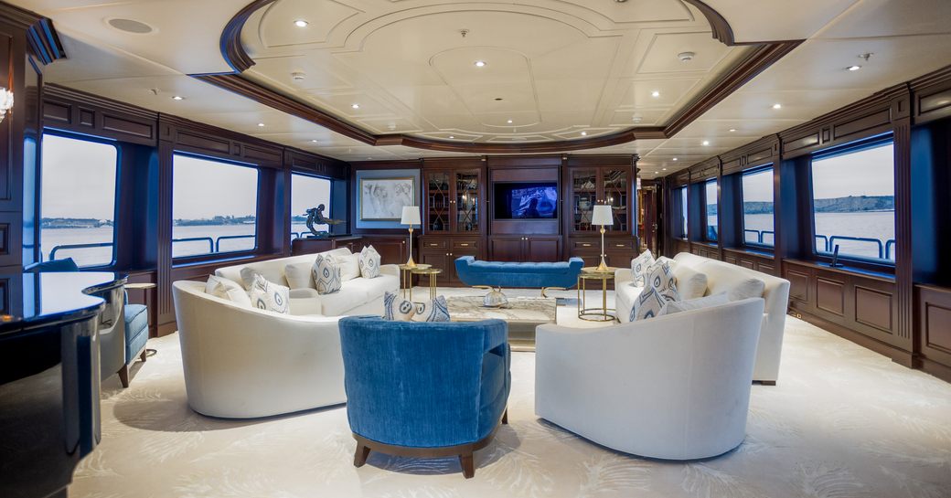 Main salon onboard charter yacht PURPOSE, spacious lounge area surrounded by windows