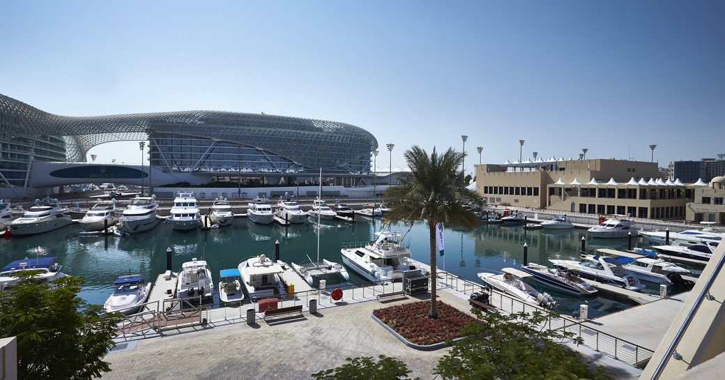 Overview of Yas Marina, home of the Abu Dhabi Grand Prix. Multiple motor yachts berthed.
