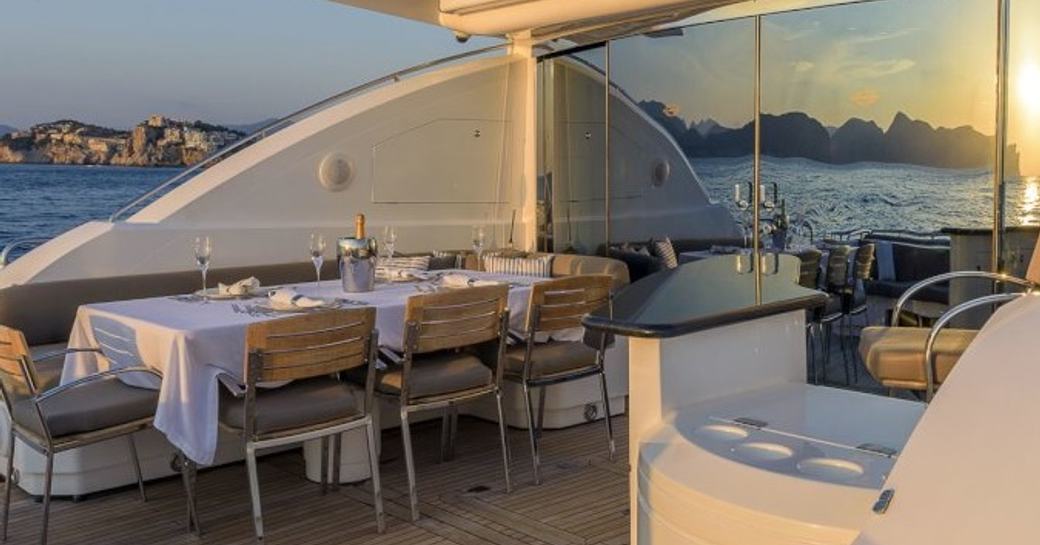 Aft deck with formal dining space on board charter yacht 'Casino Royale'