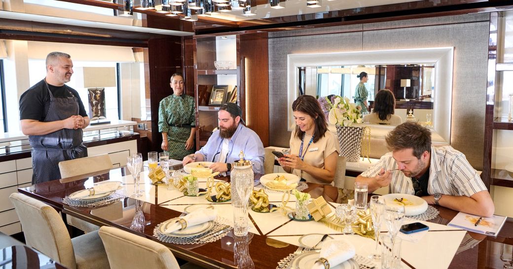 Dining area onboard charter yacht AQUA LIBRA during Chef's competition at MEDYS, with judges tasting food
