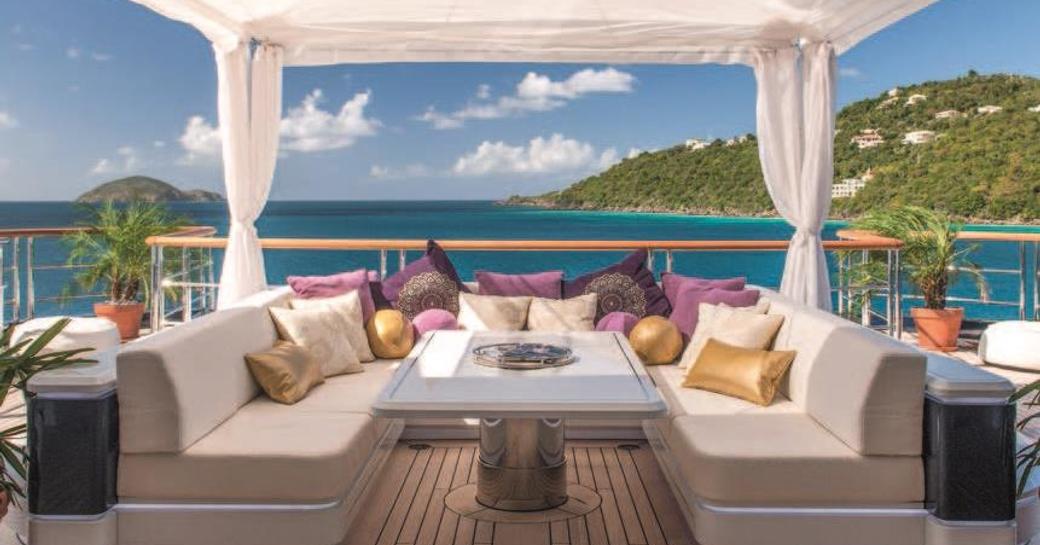 Sun deck lounging and dining on board luxury yacht Solandge