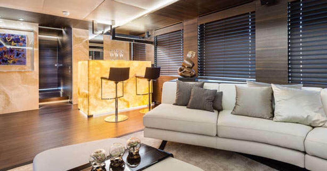 An illuminated yellow bar and contemporary furnishings on board superyacht SHADOW