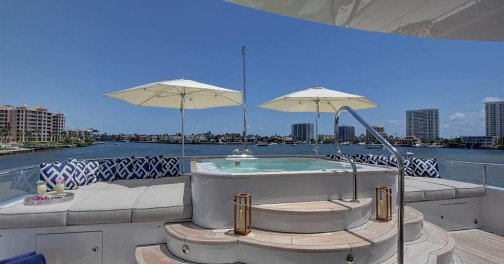 Jacuzzi and parasols with view of Miami on charter yacht AQUASITION