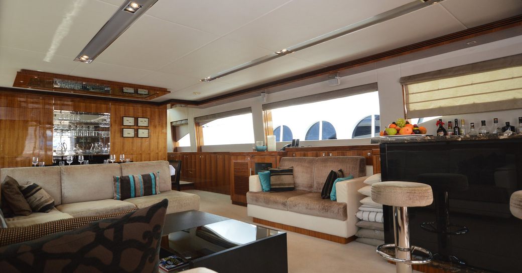 main salon with sofas and bar on board charter yacht ENCORE 