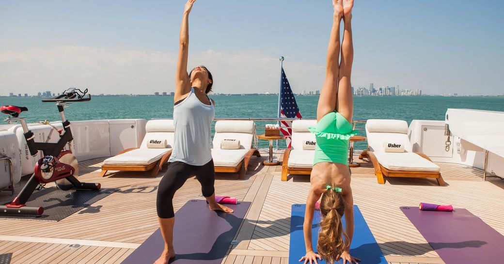 Exercising and yoga on deck of superyacht USHER