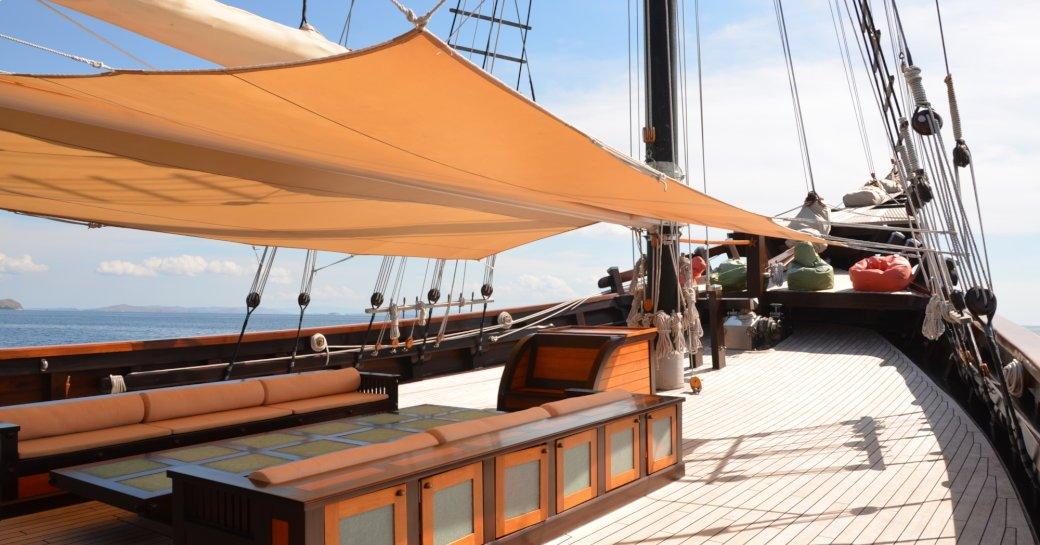 shaded seating area on the foredeck of charter yacht ‘Dunia Baru’ 