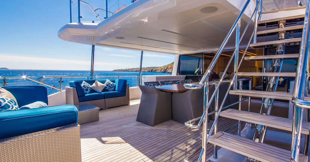 Seating and dining area on the aft deck of luxury yacht LULU