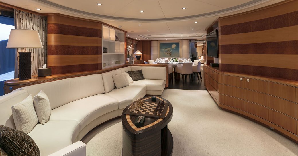 curved leather sofa in main salon of superyacht L’EQUINOX