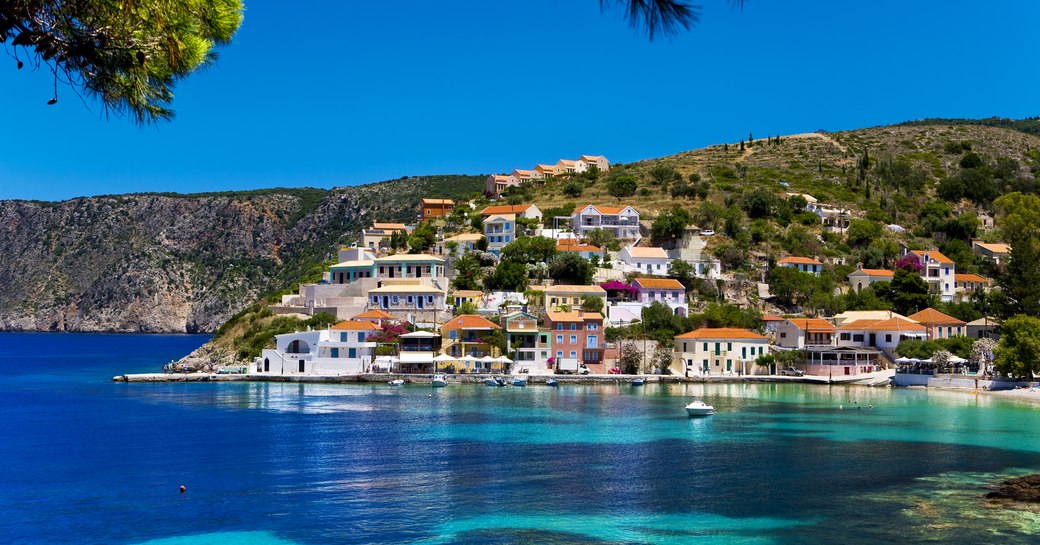 Overview of Asos village on the Greek island of Kefalonia, surrounded by azure waters.