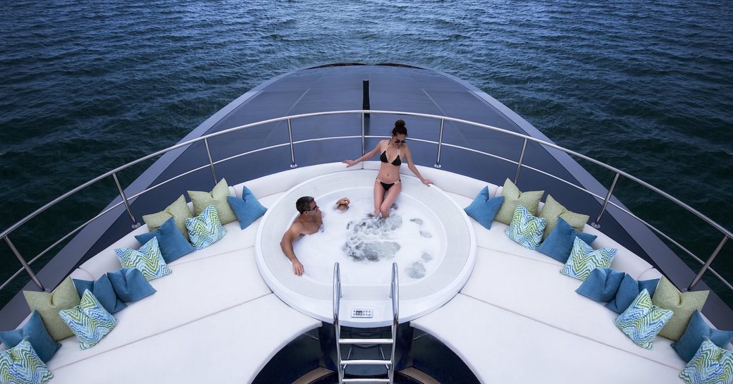 A man and woman enjoy a Jacuzzi on board superyacht 'Ocean Emerald'