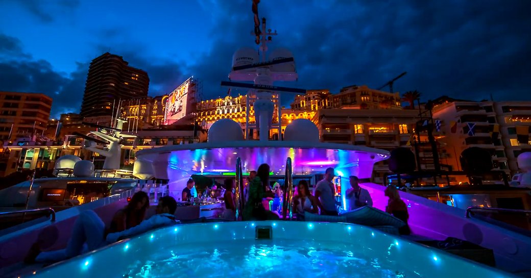 sundeck lights up as party-goers celebrate aboard a luxury yacht berthed in Port Hercules