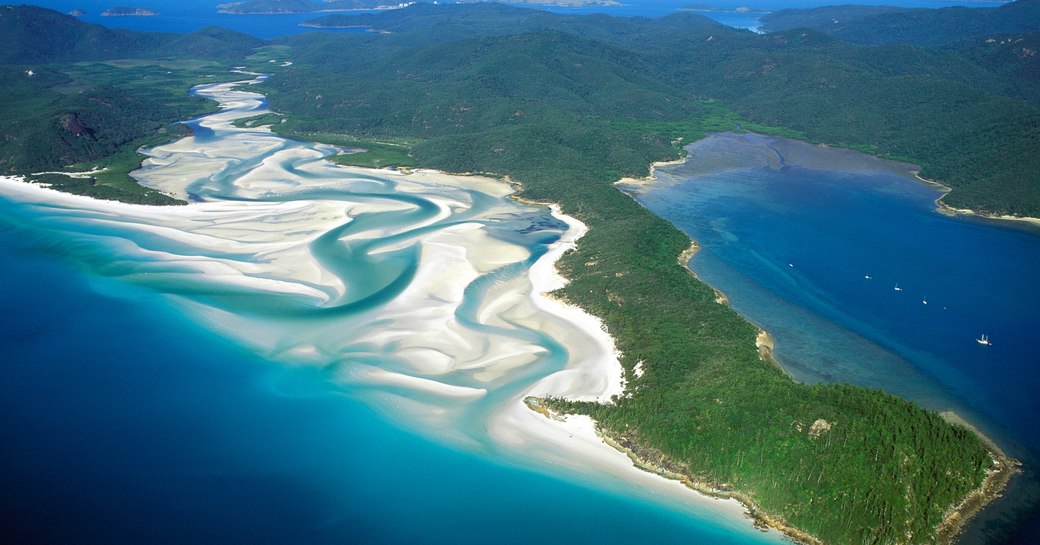 the swirling white sands and greenery of the Whitsunday Islands, Australia