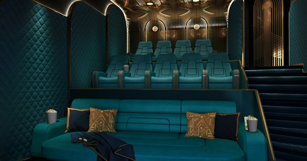 Overview of the cinema onboard charter yacht KISMET, with plush teal seating