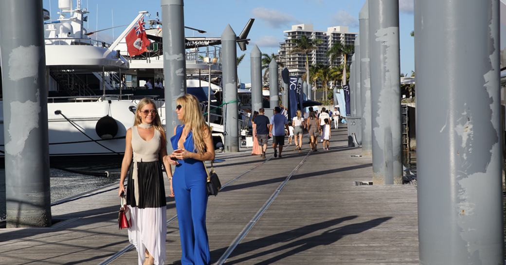 girls at miami yacht show walking the docks