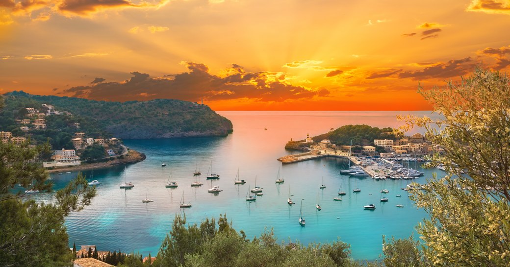 Ibiza harbor with anchored yachts at sunset