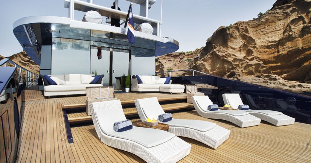 Sun deck with sun loungers and seating aboard luxury yacht BLADE